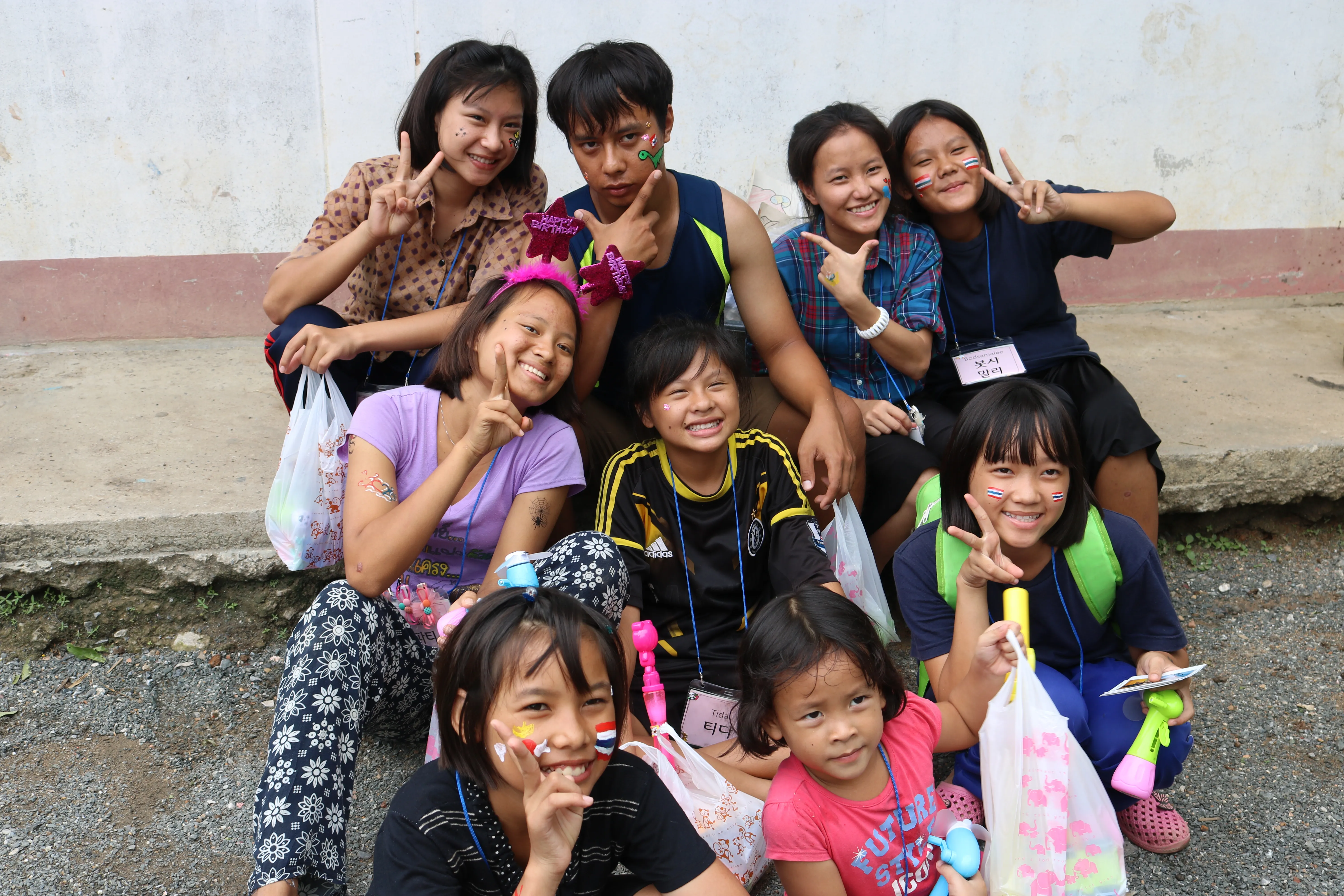 YCF children smiling together with face paint